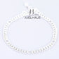 JUELHAUS  Silver Baby Bracelets with Stylized Single String Bells Interspersed with Long Round Eyes