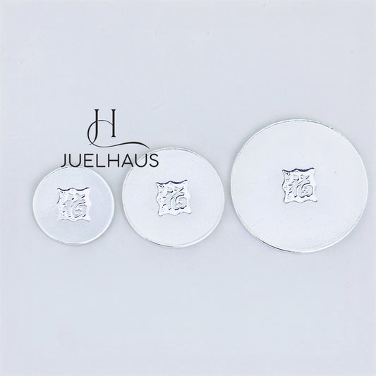 JUELHAUS Smooth, wind-scraped silver coins come in many sizes